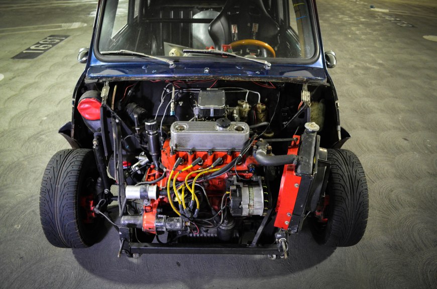 The whole front clip was cut off by the previous owner and replace by a full fiberglass hood. Headlights and turn signals are connected by wire connecters located near the brake master cylinder.